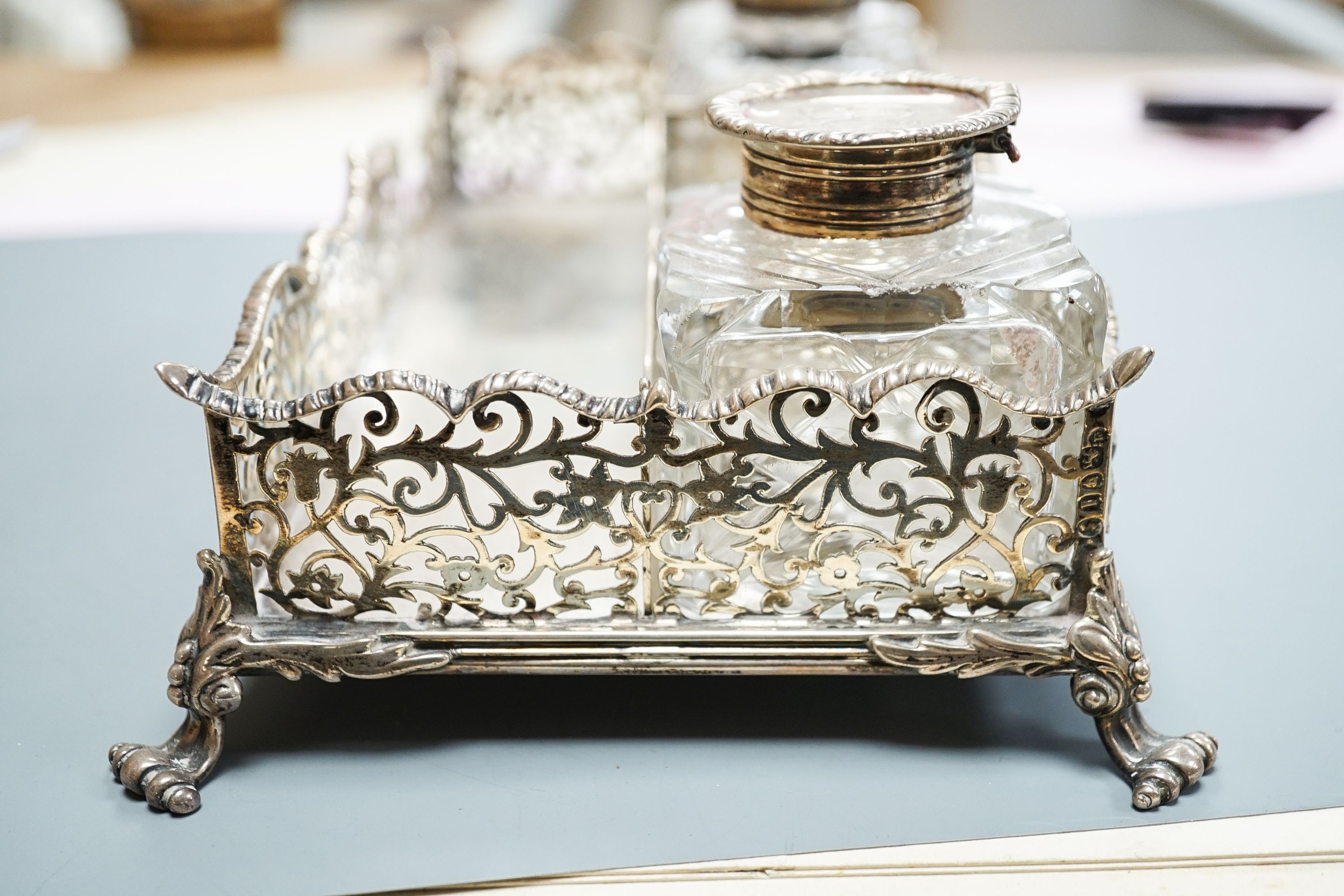 A late Victorian pierced silver twin inkstand, with two mounted glass inkwells, (a.f.), London, 1884, 25.3cm, 18.5oz.